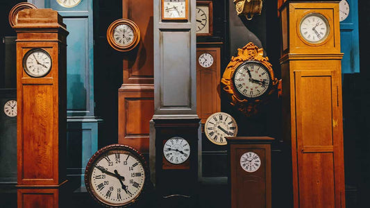 Lots of grandfather clocks with different time